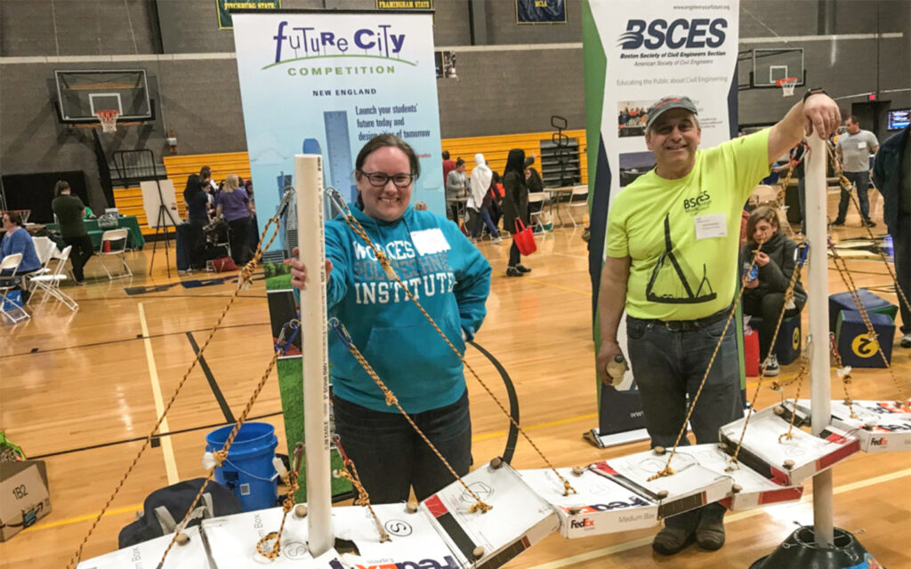 Photo of Alyson and her Regional Co-Coordinator Reed Brockman show off a student-built model of the Zakim Bridge, created as part of Future City.