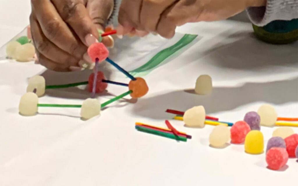 Close up photo of Benesch employee creating a mock-up molecule at the ACEC of Georgia’s annual Introduce a Girl to Engineering event