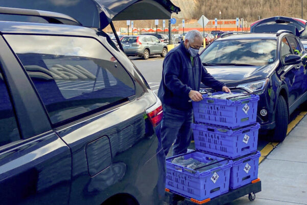 Benesch employee dropping off food items collected during the 2020 Food Drive