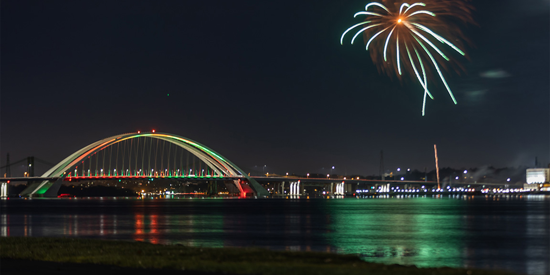 Side view photo of fireworks at I-74 Mississippi River Bridge