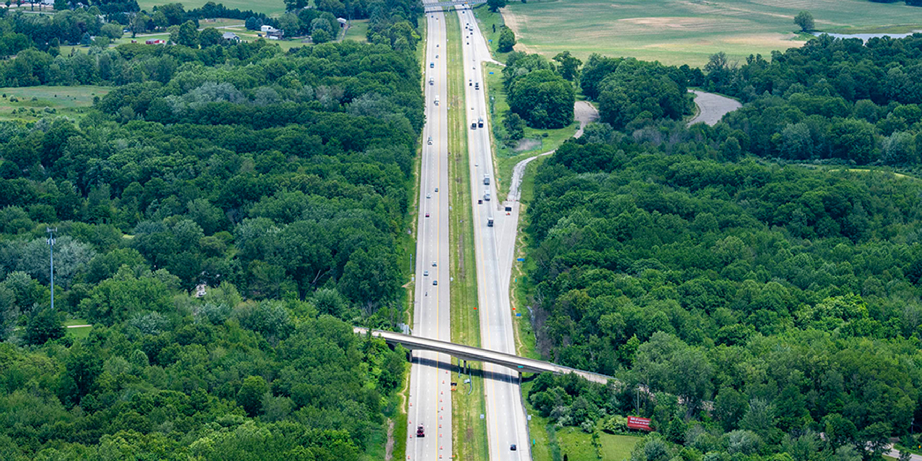 A photo from above of highway from above and a highway bridge