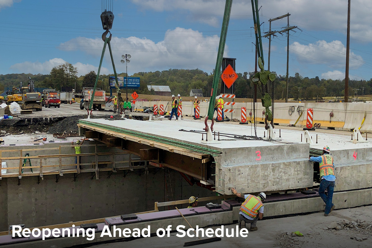 photo of construction crews dropping a precast structure into place for an overpass replacement over train tracks on the Pennsylvania Turnpike