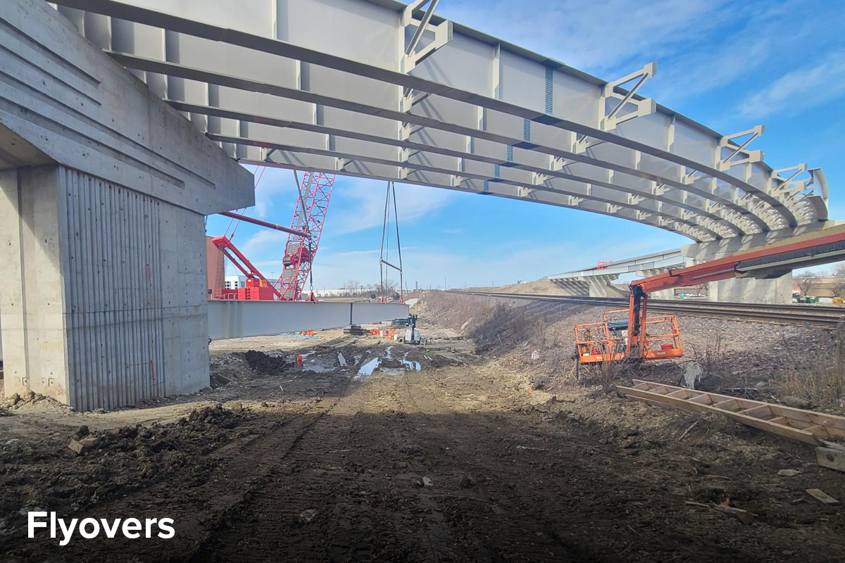 photo of the new Elgin O'Hare flyover structure during construction, showing curved girders spanning the construction site