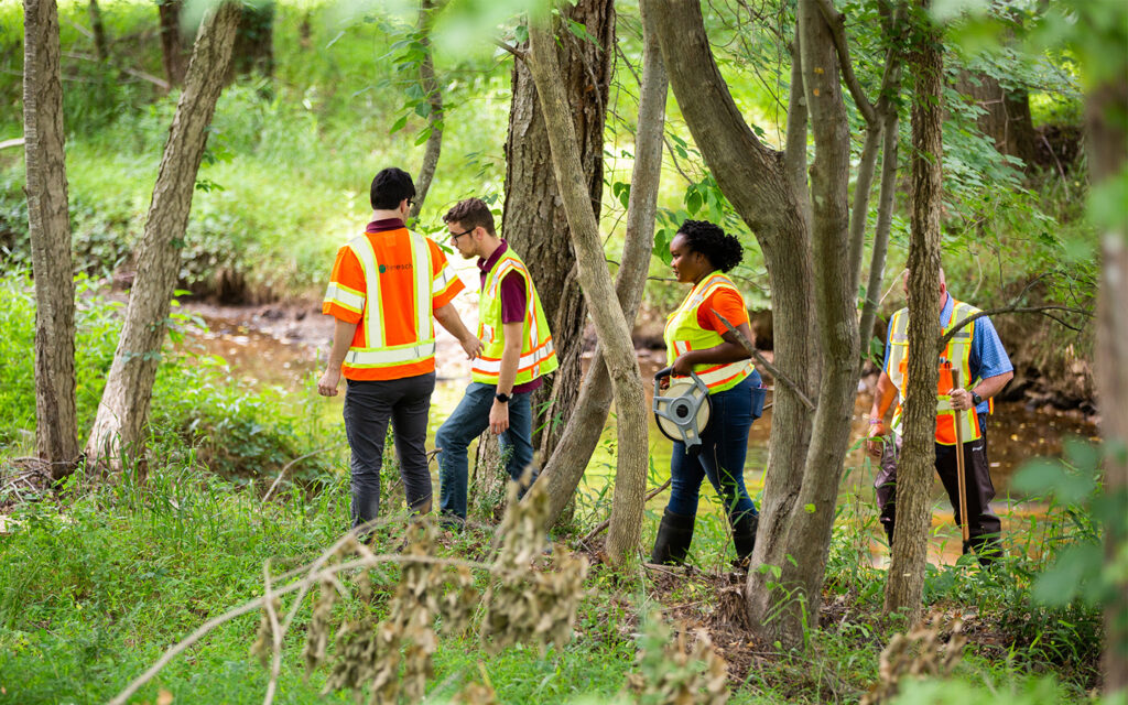 Photo of Benesch employees performing field work