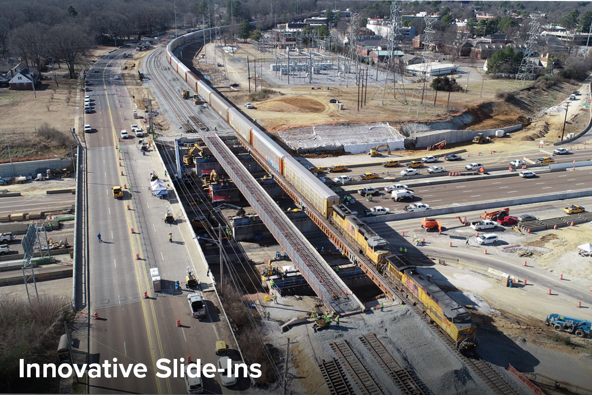 aerial view of train passing over a new bridge spanning I-240 in Memphis as construction on the second bridge continues