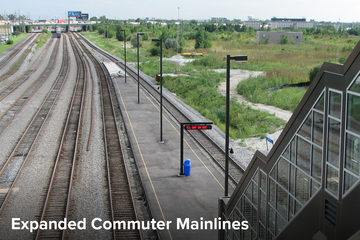 View of several new tracks on the North Central Metra line in Chicago heading toward the city, with an outdoor train station platform in the foreground