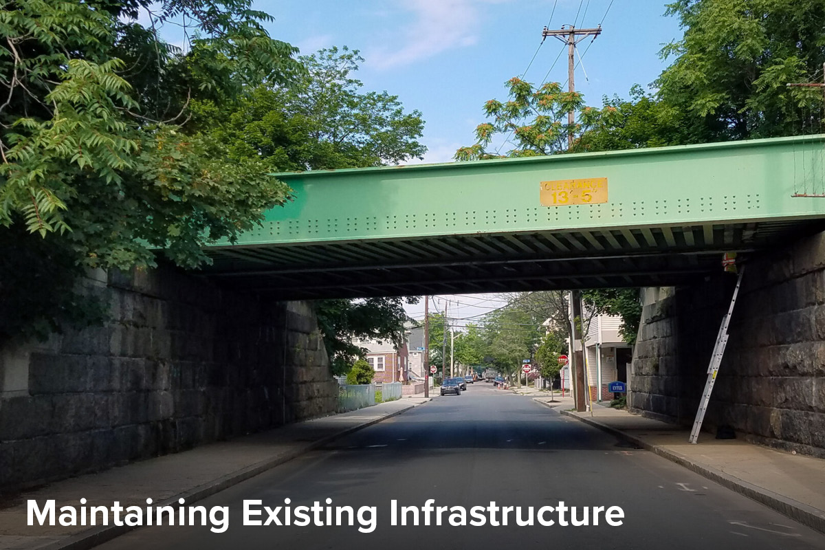 view of a small bridge over a roadway in Boston carrying the MBTA transit line