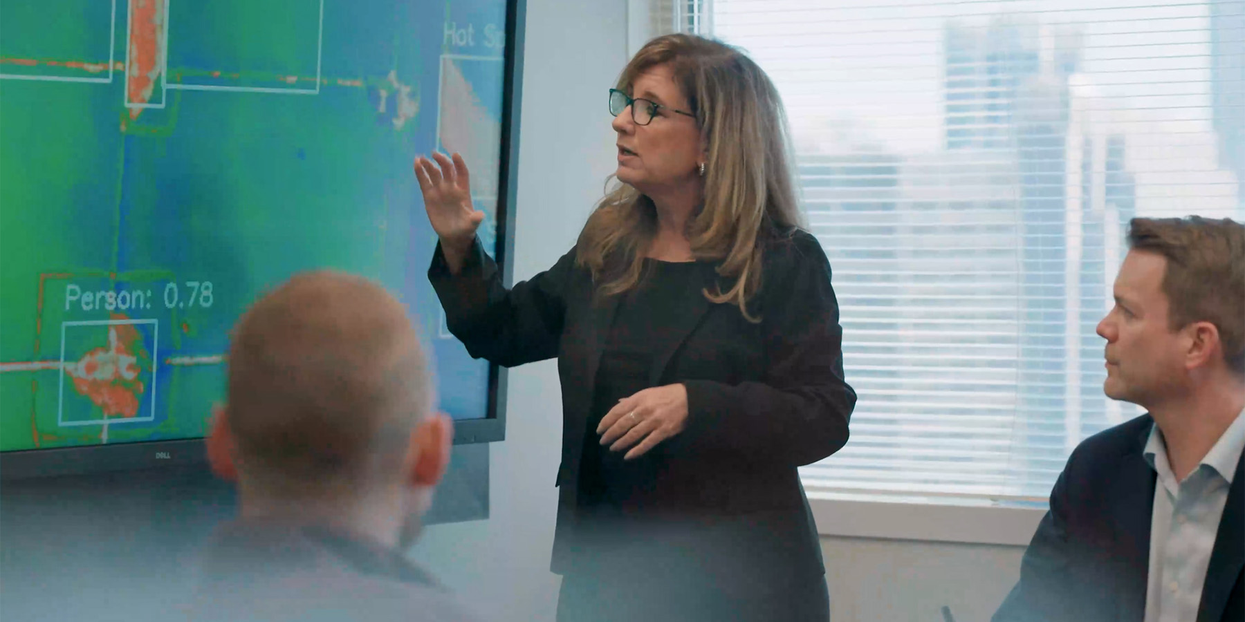 Benesch employee leading a brainstorming session in a conference room