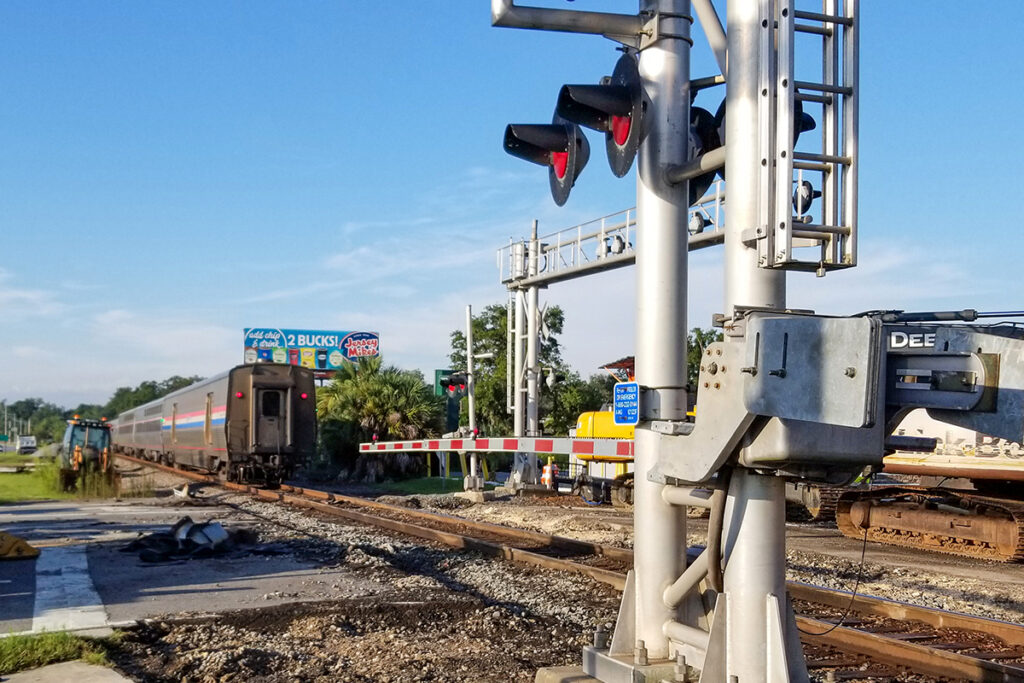 photo of San Juan Avenue grade crossing under construction as an Amtrak train passes through