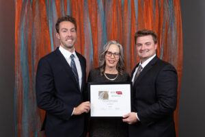 A photo of the Kearney Regional Airport team with the award and Jeanne McClure