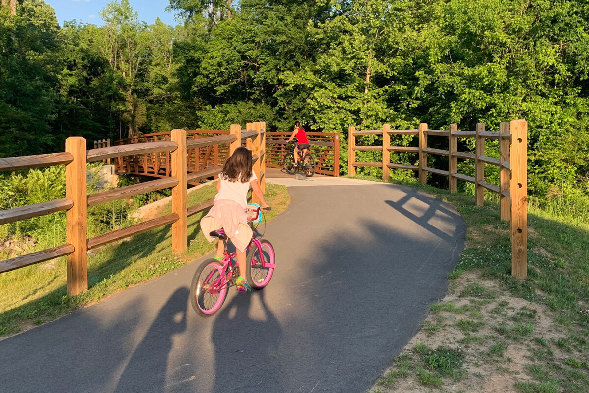 Photo of a family bike riding at Irish Buffalo Creek Greenway in North Carolina