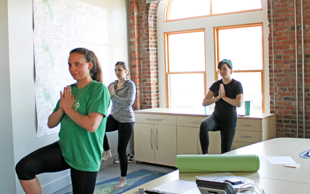 Group photo of Benesch employees practicing yoga