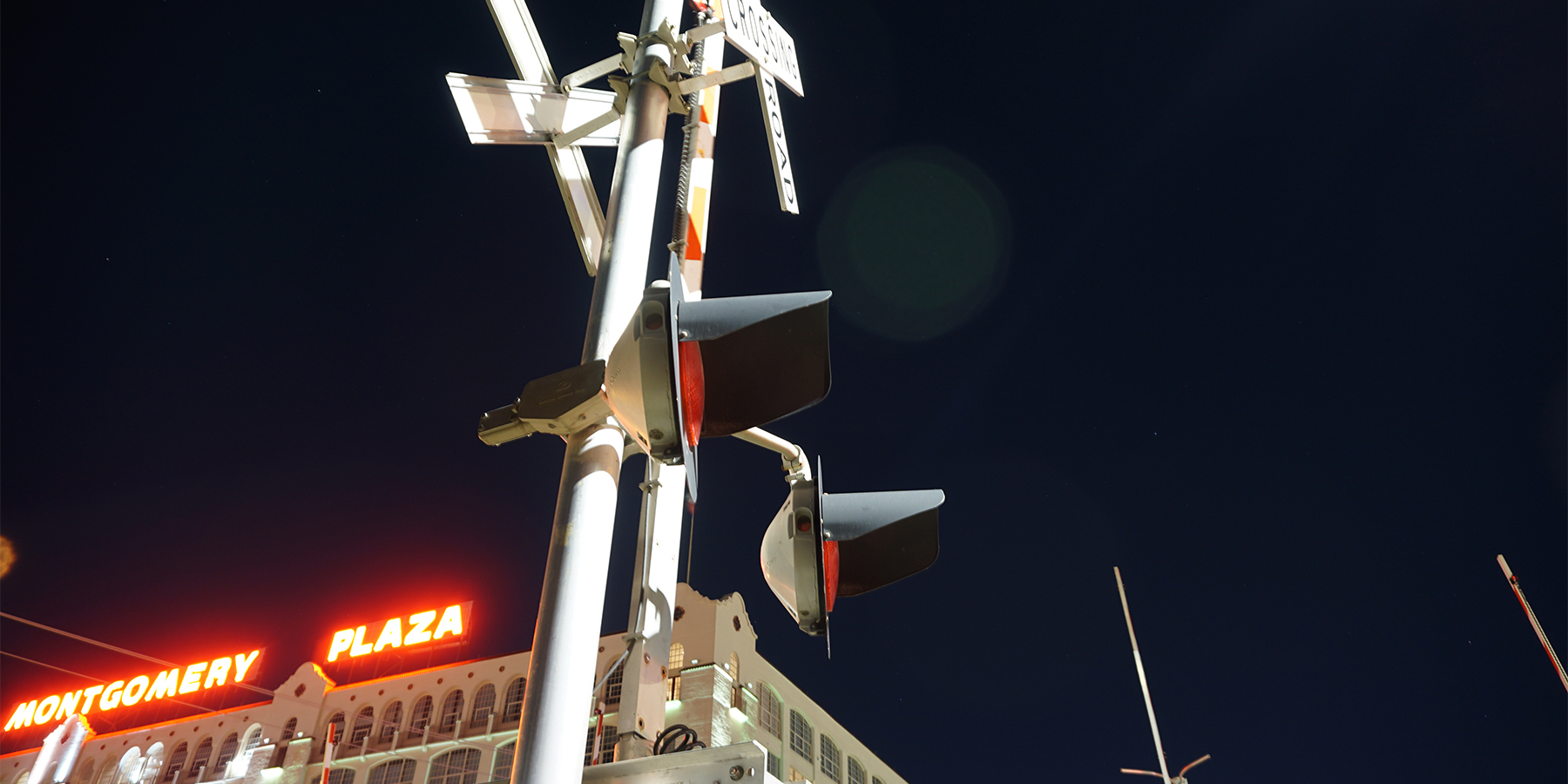 photo of a grade crossing signal at night