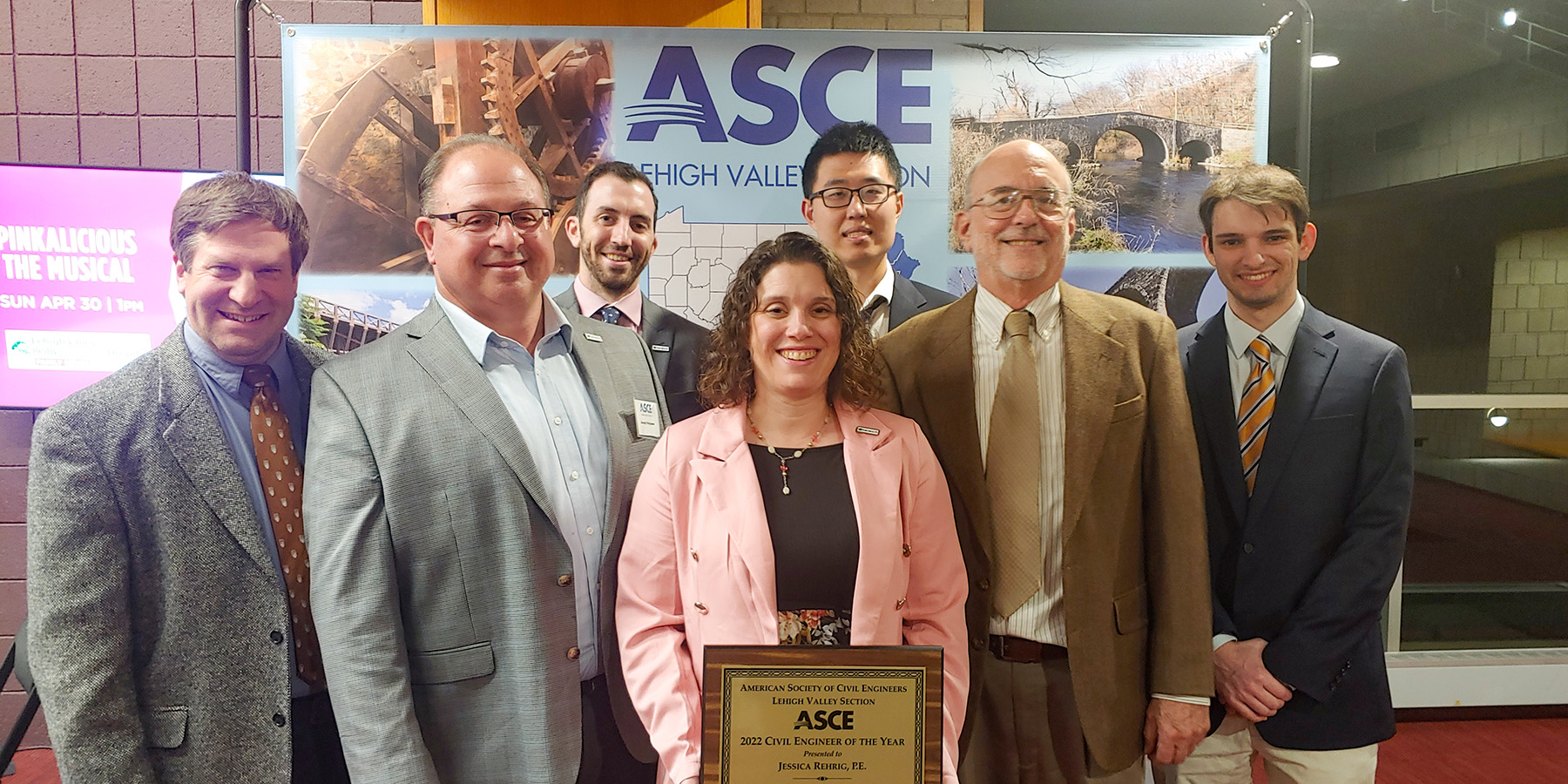 A photo of Jessica Rehrig holding ASCE award with Benesch team