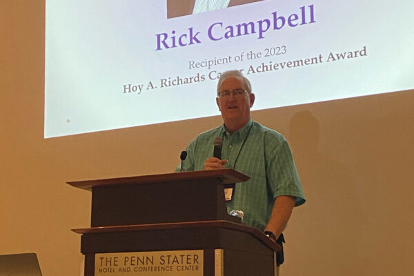 A photo of Rick Campbell talking at podium