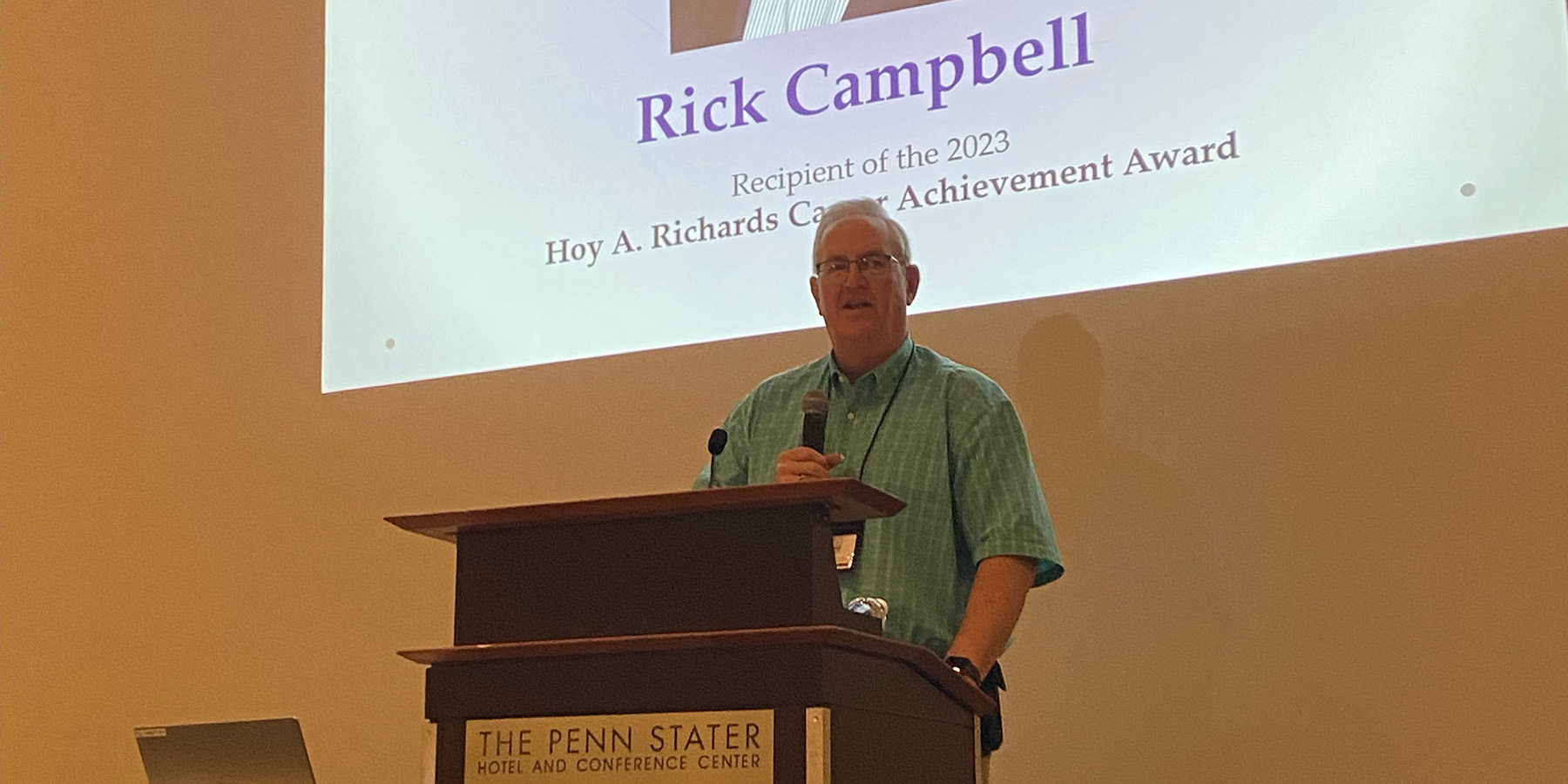 A photo of Rick Campbell talking at podium