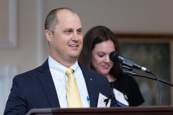 A photo of Ryan Scrittorale speaking at podium