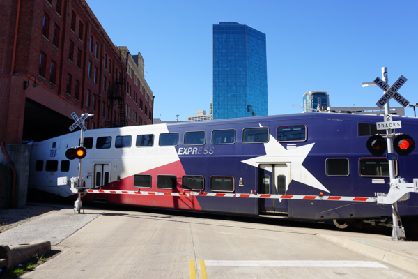 Train crossing a road in a city