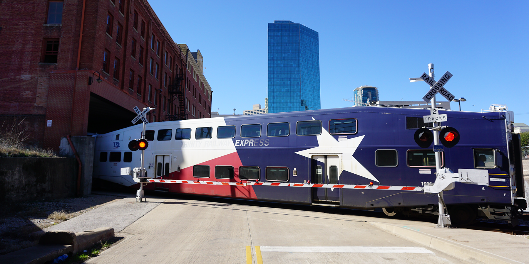 Train crossing a road in a city