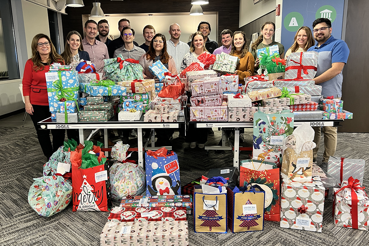 a photo of Benesch's Chicago office team after wrapping gifts for children as part of a charitable giving event in December