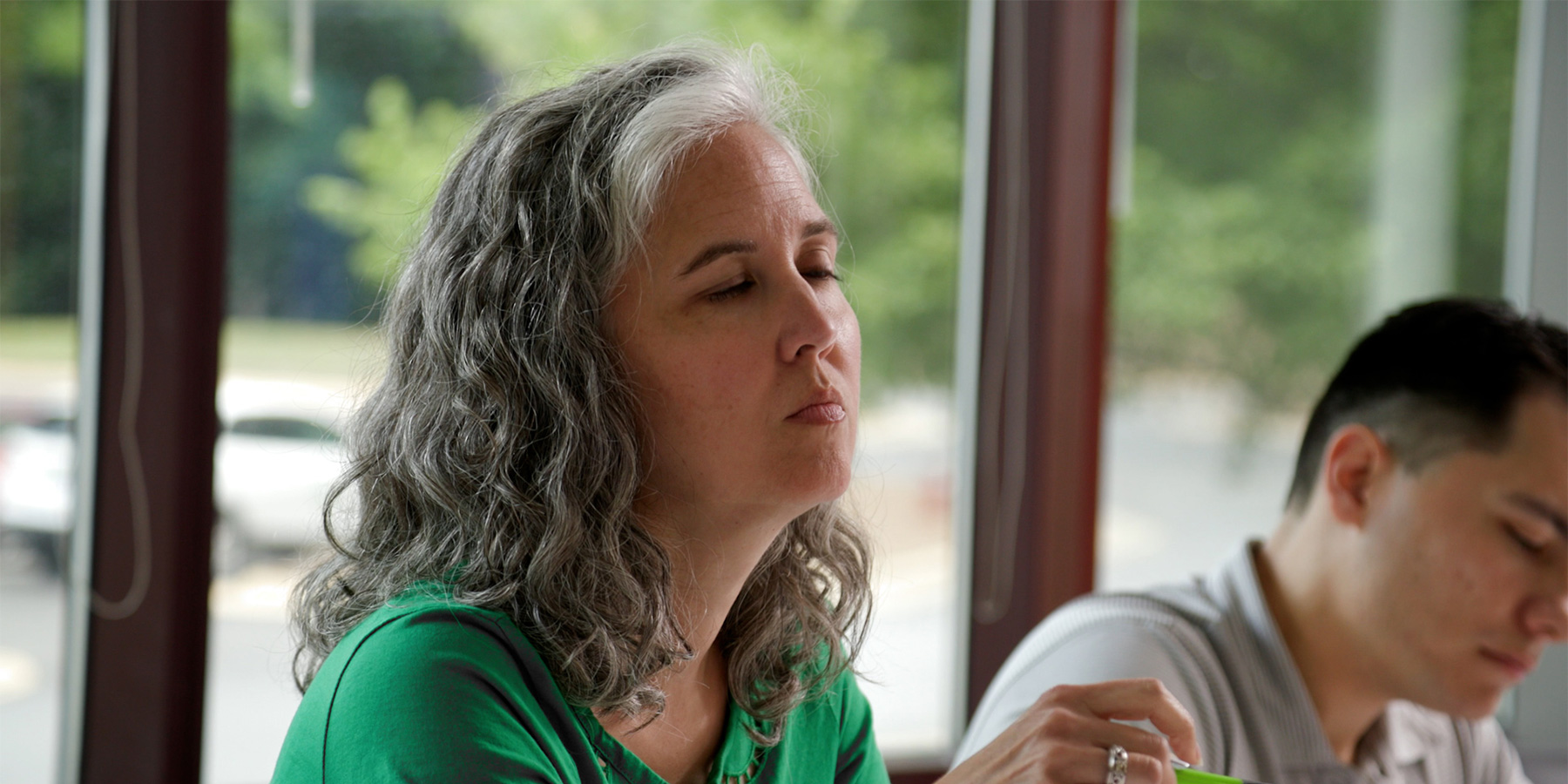 Close-up photo of Benesch's staff talking during a meeting in a conference room