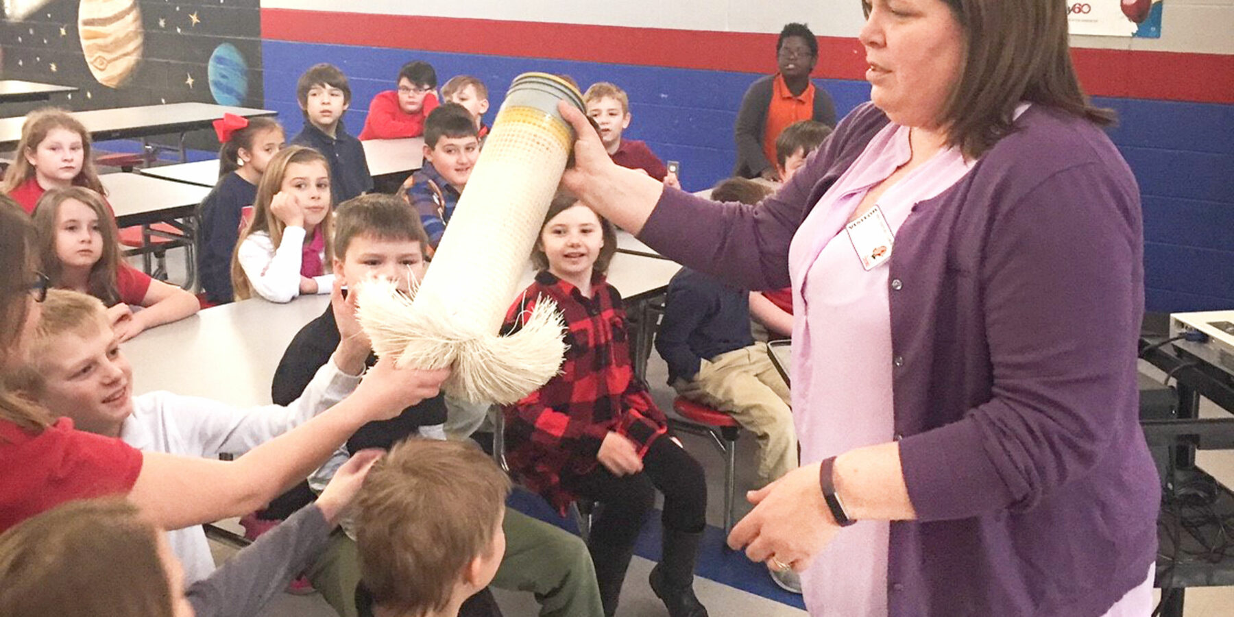 a photo of a Benesch engineer teaching an elementary school about water engineering