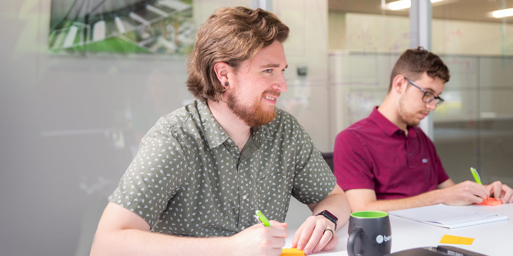 a photo of two Benesch team members working at a table