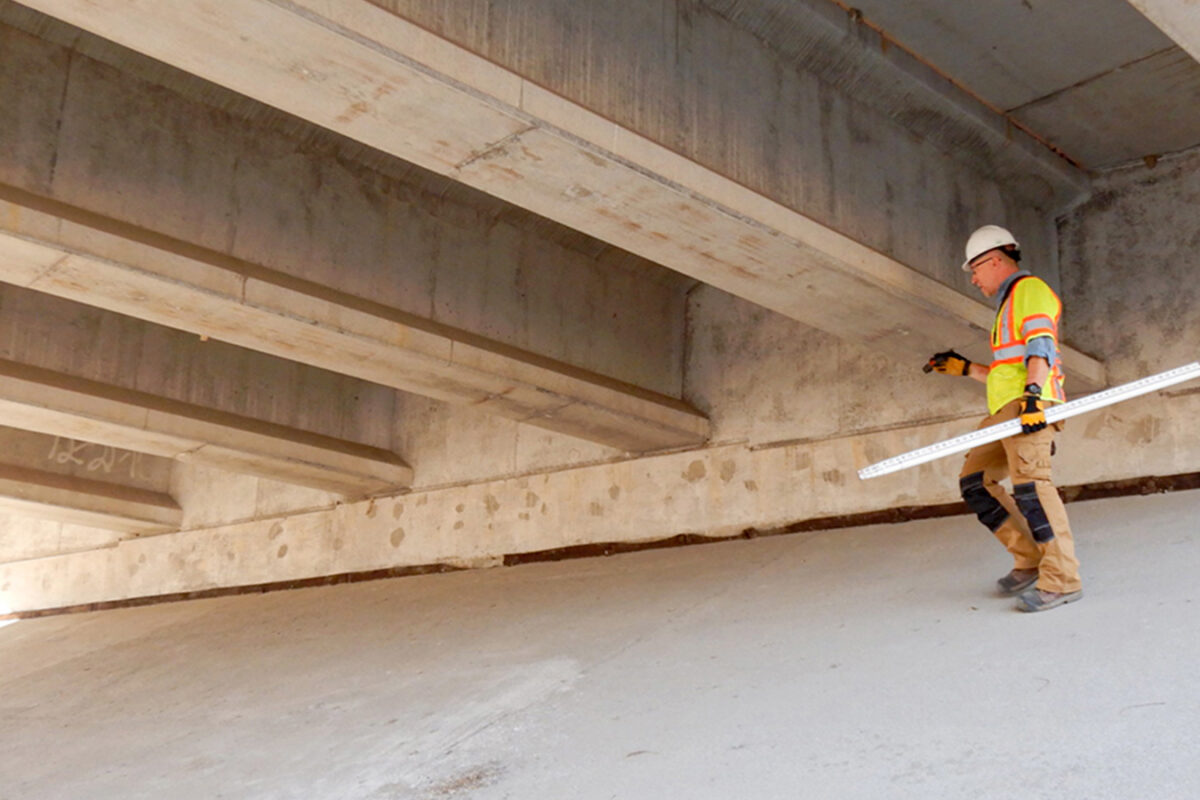 Photo of Benesch employee performing a bridge assessment