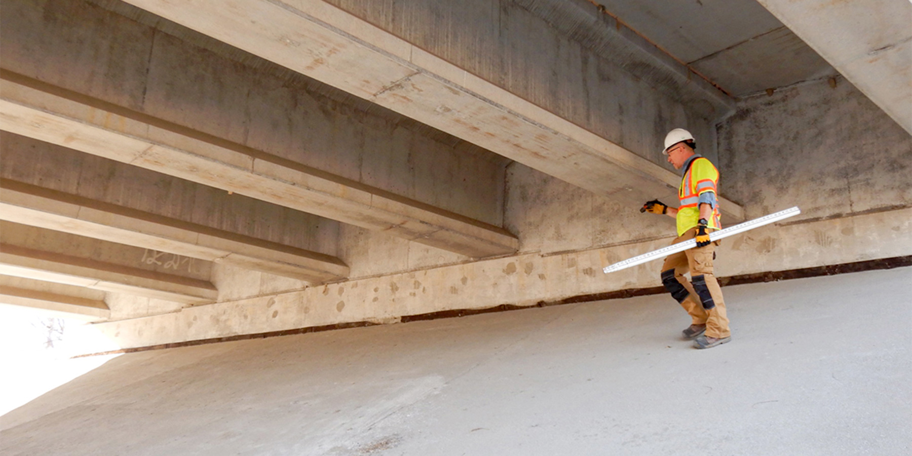 Photo of Benesch employee performing a bridge assessment