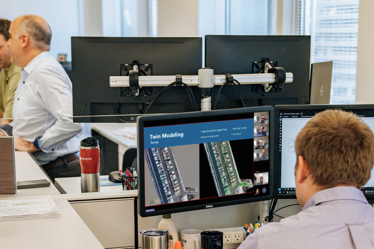 image of Benesch employee watching an in-house training video about digital twins on his computer at his work station