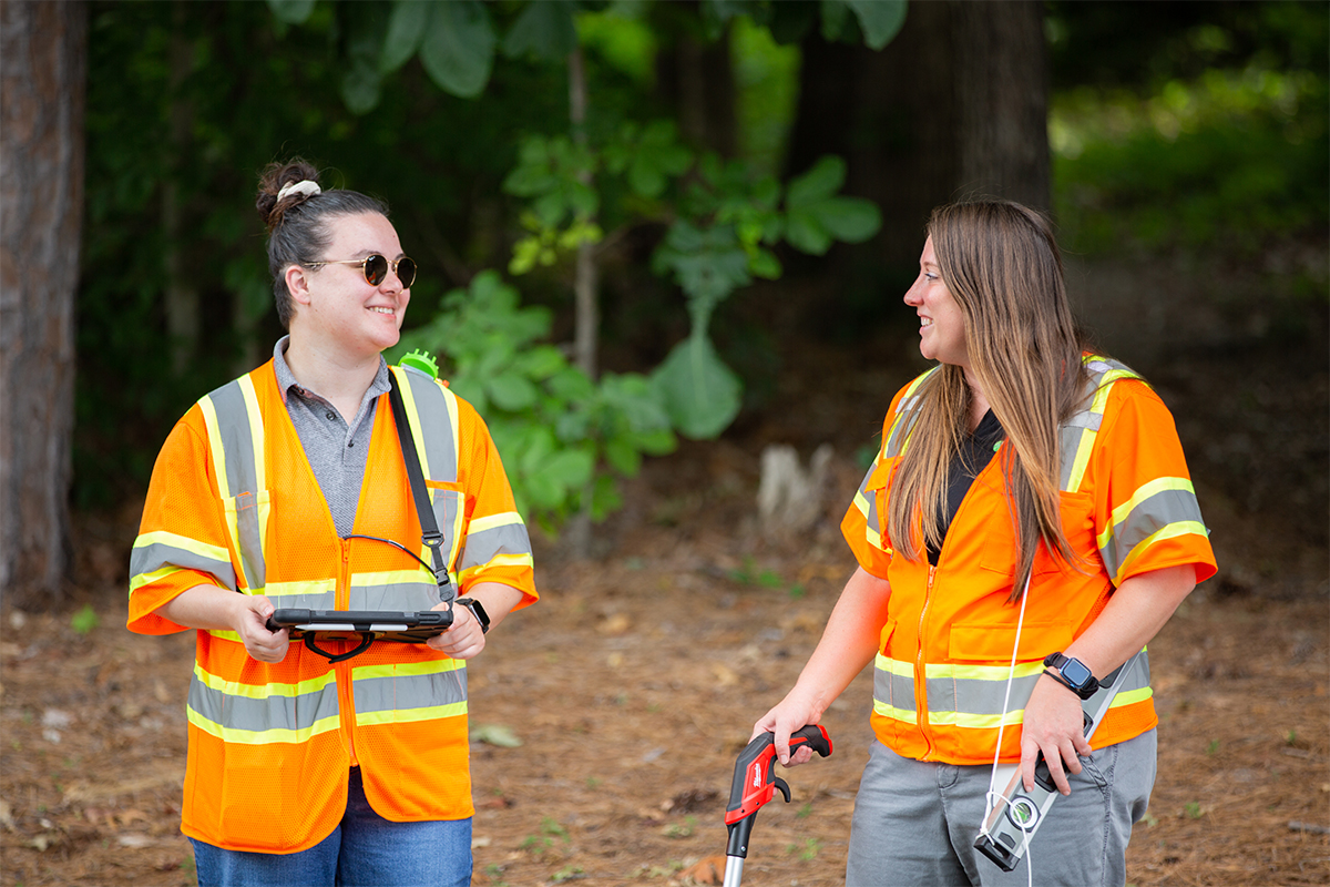 photo of Benesch team members taking pavement measurements on a street