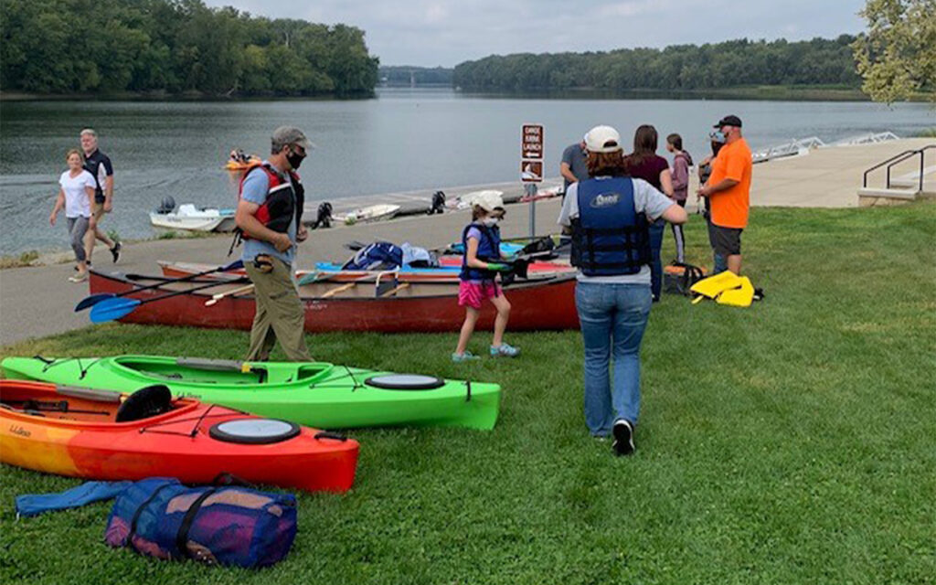 Photo of Benesch's employees getting ready to kayak and clean the river in Glastonbury, CT