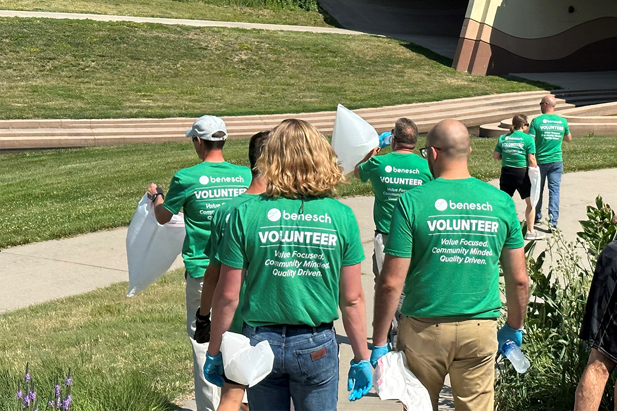 Benesch employees clearing debris in a along a highway during a summer service outing