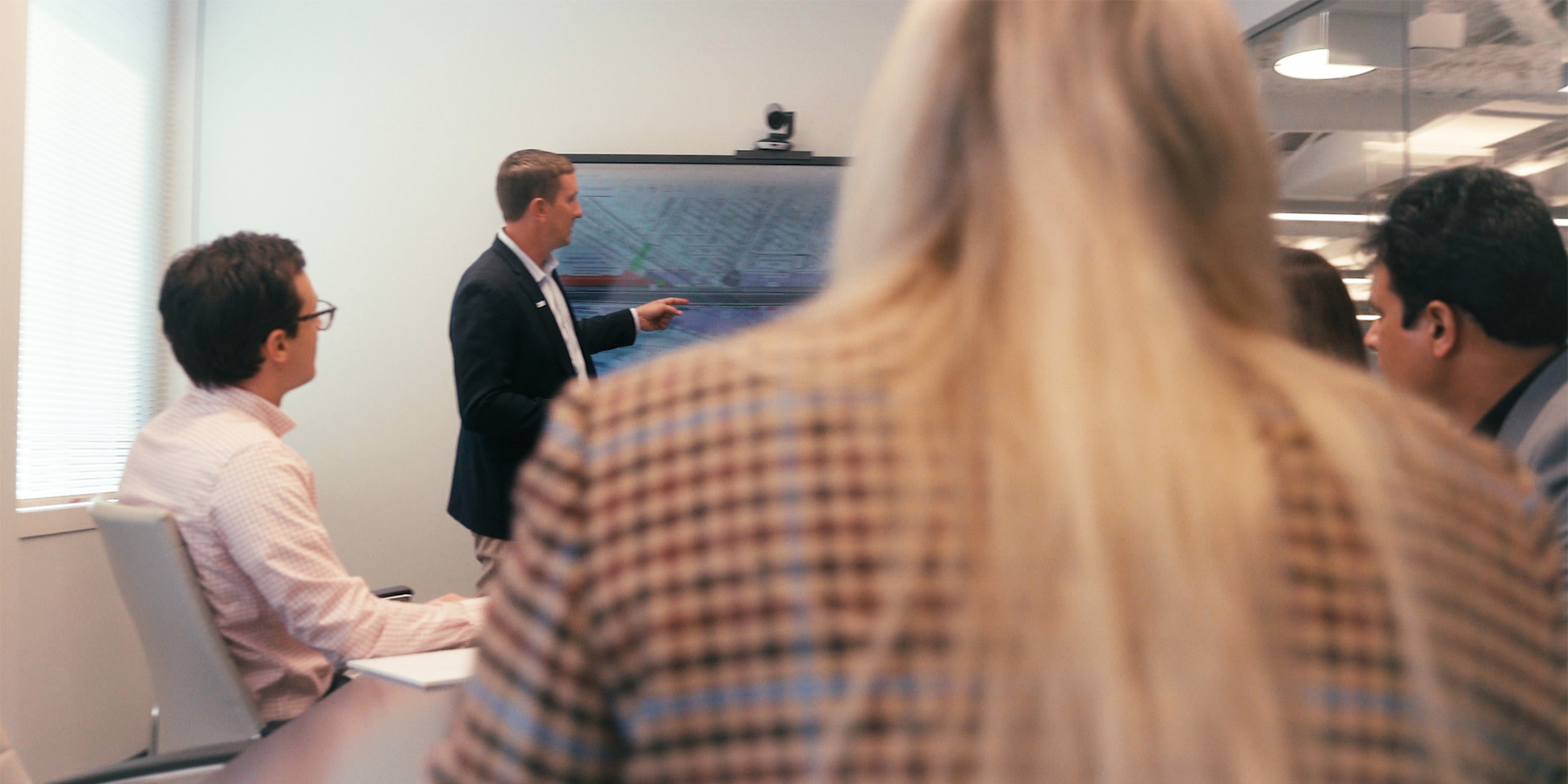 Group photo of Benesch's staff having a meeting in a conference room