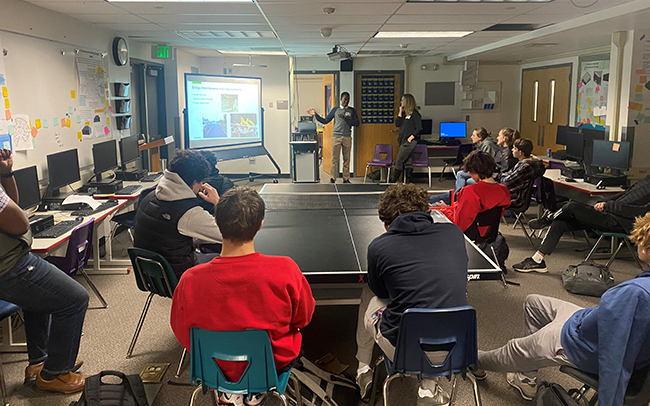 A photo of students watching a presentation about bridge engineering