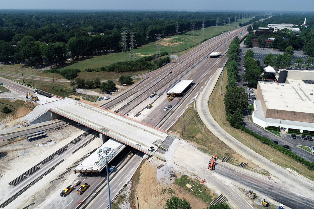 Aerial image of new roadway bridges loaded onto self propelled modular transporters as they are moved down the interstate to their final permanent locations