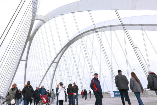 Photo of people walking on I-74 Bridge over Mississippi River after opening