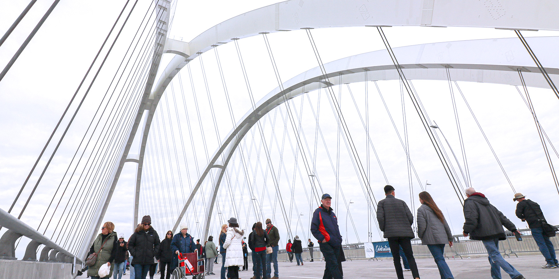 Photo of people walking on I-74 Bridge over Mississippi River after opening