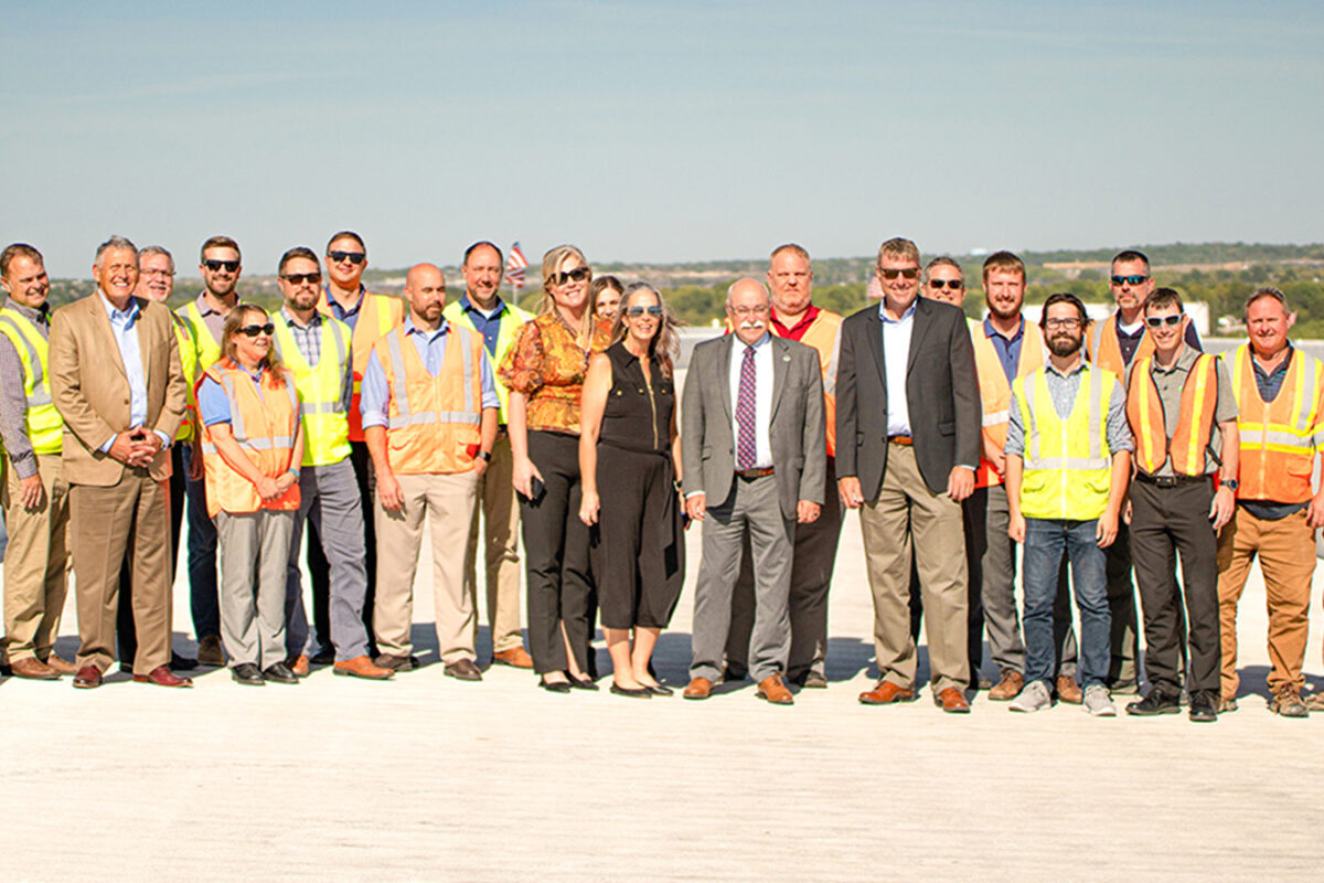 A photo of a large group of Benesch employees wearing construction outfits