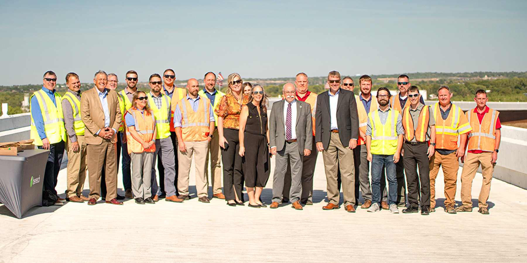 A photo of a large group of Benesch employees wearing construction outfits