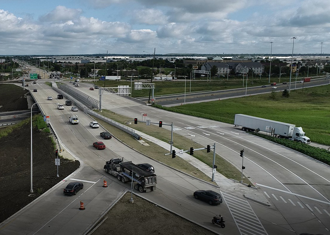 A photo of Weber Road and I-55 interchange from above showing cars and trucks driving