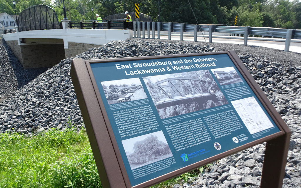 Photo of an interpretive panel explaining the history of the Delaware-Lackawanna Railroad at the Ridgeway Street Bridge in Pennsylvania