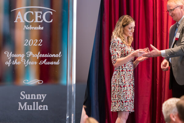 Photo of Benesch employee Sunny Mullen receiving the ACEC Nebraska Young Professional of the Year Award