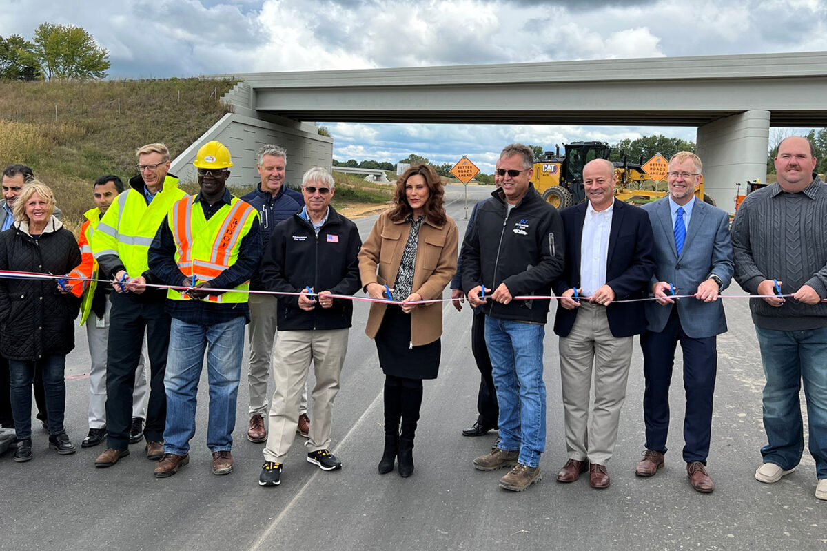 A photo of the group cutting the ribbon together at US-31