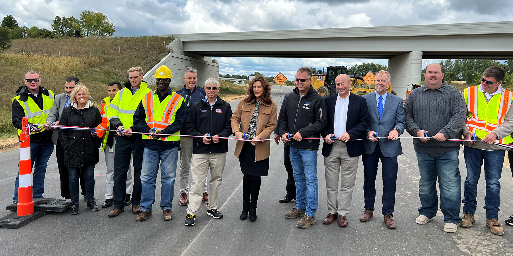 A photo of the group cutting the ribbon together at US-31