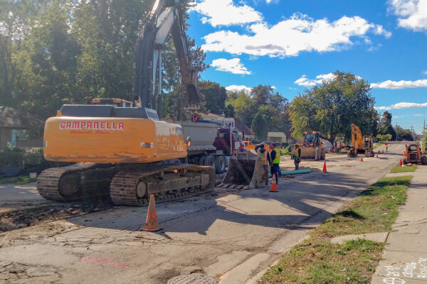 photo of construction on Hawley street, showing a large piece of construction equipment in the street with traffic cones