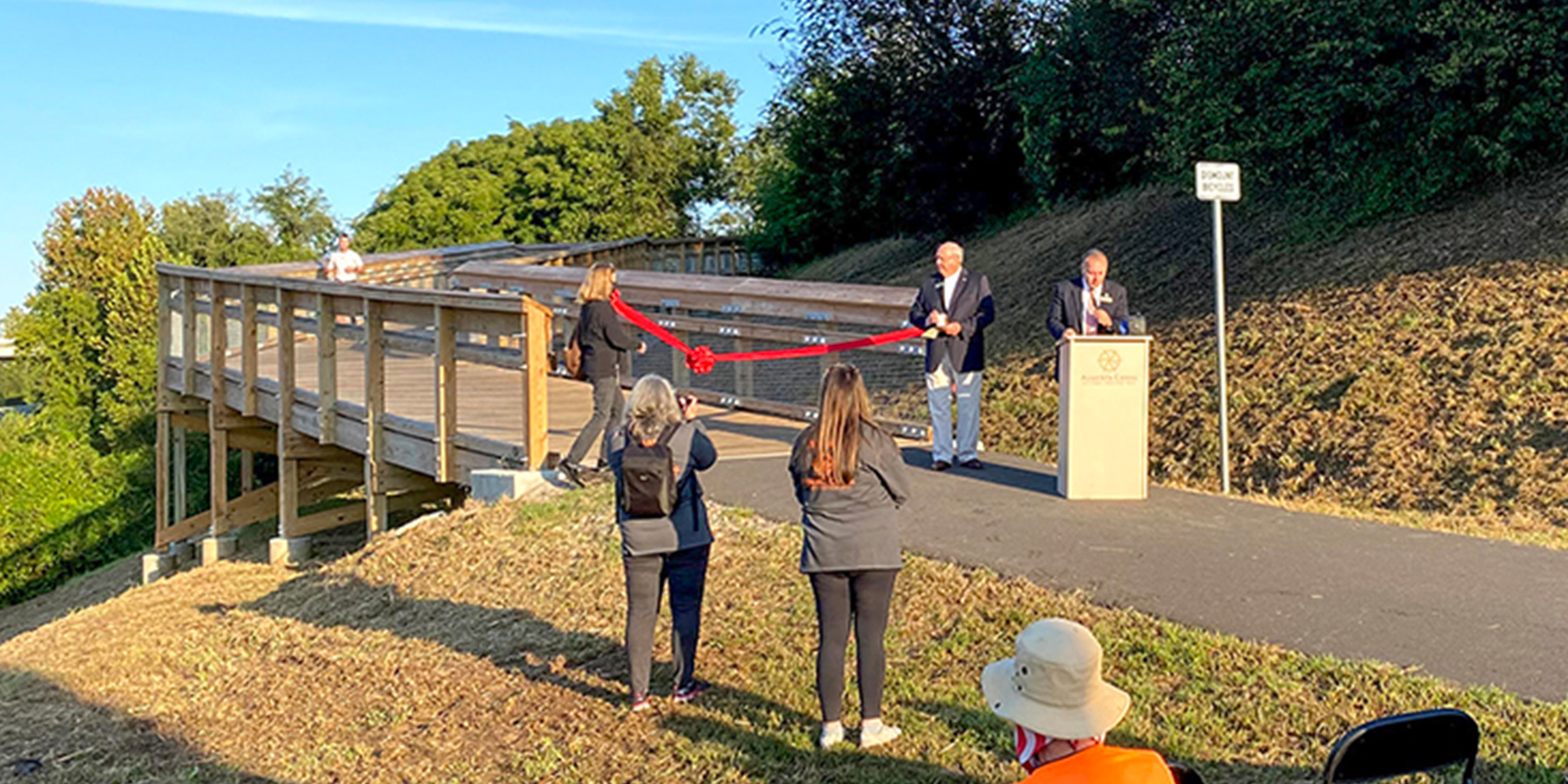 Photo of the ribbon cutting ceremony of the Phase IIID of the River Levee Trail during the Hawk’s Gully Hurdle 10K.