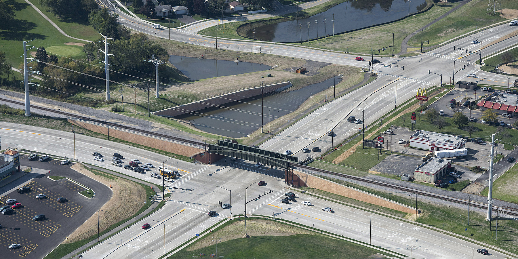 Aerial view of the Rollins Road Gateway, which includes a new railroad bridge crossing over the intersection of IL 83 and Rollins Road in Round Lake Beach, IL