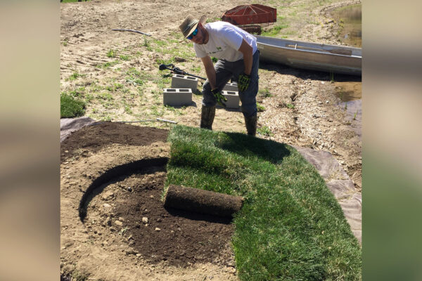 Photo of Benesch's employee setting up the structure for a floating island in Omaha