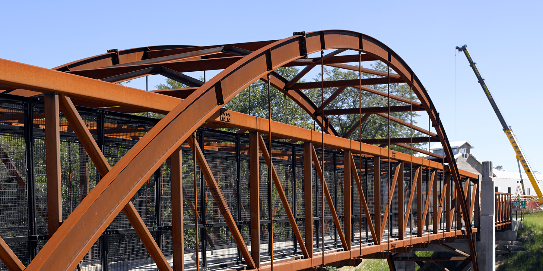 image of construction of a pedestrian bridge over water in Three Bridges Park in Milwaukee, WI